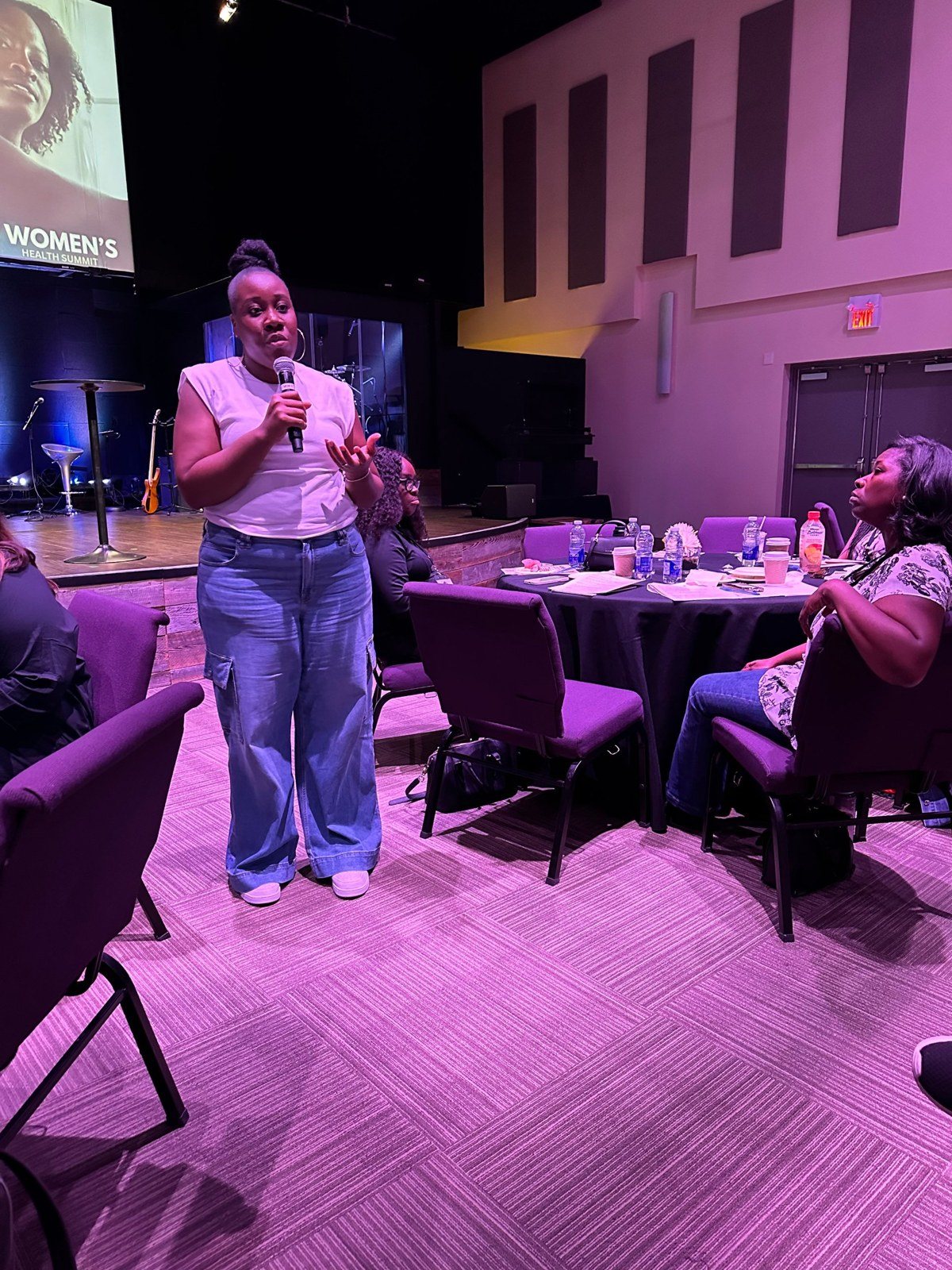 Jessica Robinson-Grant speaking with attendees at the Women’s Health Summit